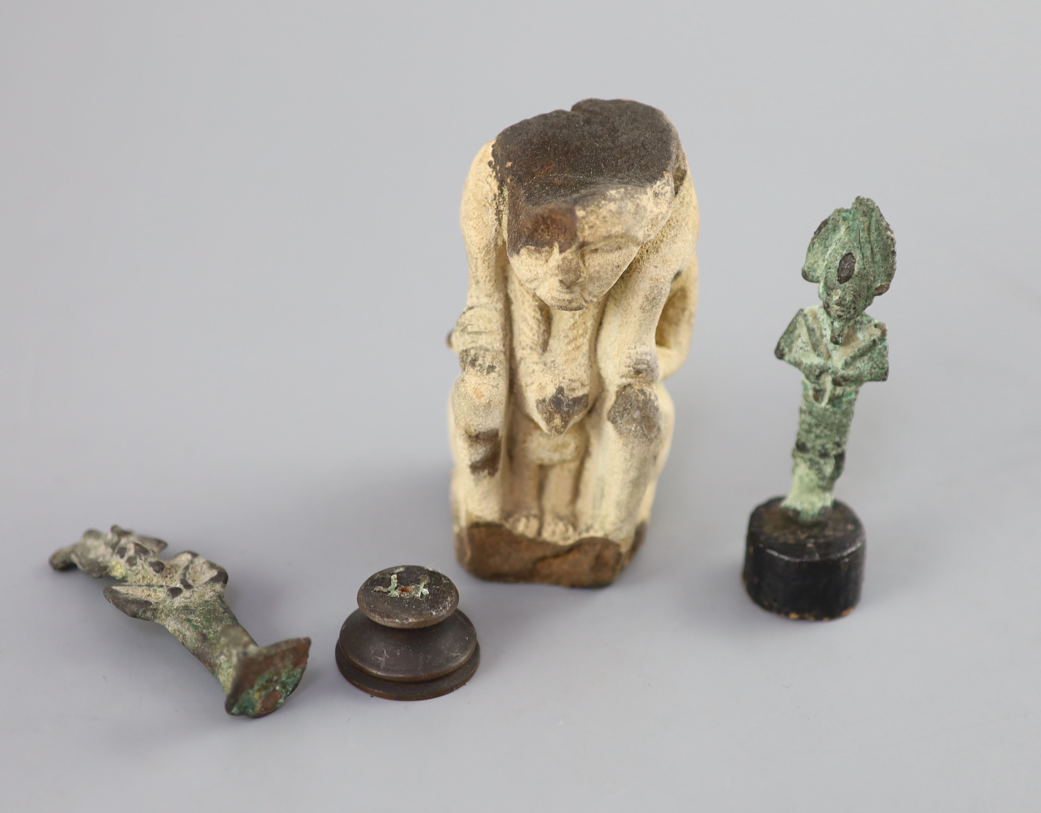 Two Egyptian bronze statuettes of Osiris and a sculpted limestone figure fragment, Ptolemaic period, Provenance - A. T. Arber-Cooke